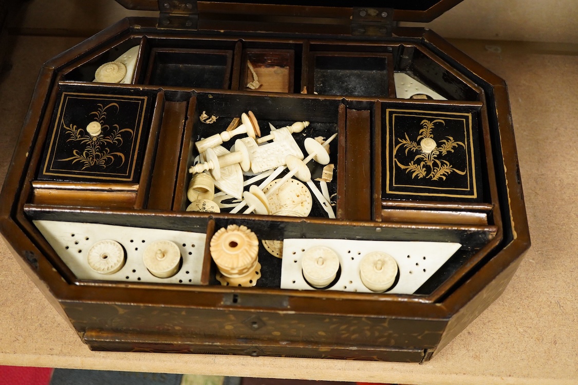 Three 19th-century Chinese gilt-decorated black lacquer sewing boxes, two containing bone sewing accessories, together with a similar tea chest (4) largest box- 33.3cm wide x 20cm high